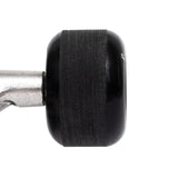 Close-up of a black wheel on a skateboard truck  on a white background with stone ground contact patch